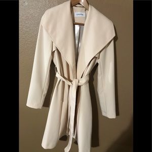 Calvin Klein cream colored trench coat, size small, button front, belt, lined